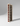 Wooden wine rack with red wine bottles on a gray background