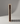 Wooden wine rack with six bottles of red wine on a gray background